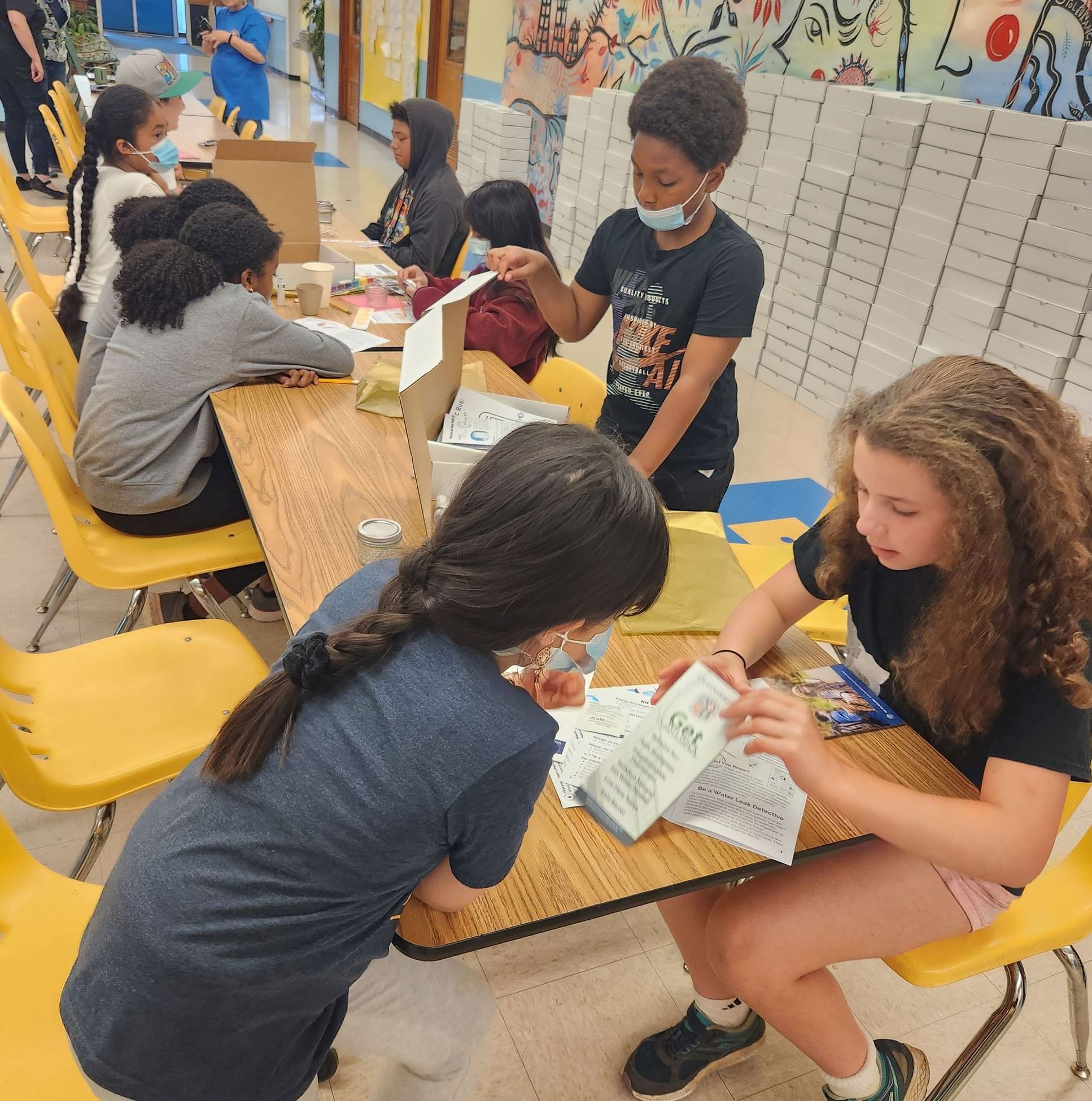 Kids checking out the 2023 Energy and Water Management Program Climate Action Kits